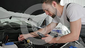 Mechanic service inspects current flow automobile