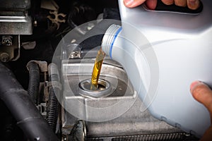 Mechanic in service to repair the car, change lubricant oil