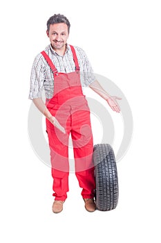 Mechanic showing new car tire