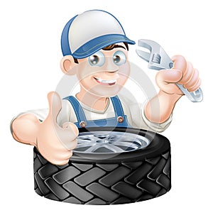 Mechanic with spanner and tire photo