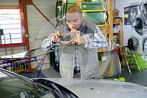 Mechanic taking photograph car