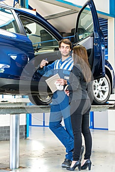 Mechanic talking to car owner