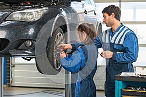 Mechanic teaching an intern in a garage