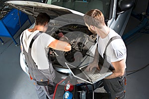 Mechanic team repair car photo