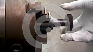 Mechanic threads ring gauge on a CNC lathe.