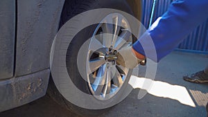 Mechanic tightening wheel nuts on a vehilce in auto service