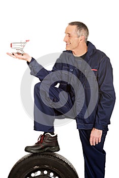 Mechanic with a tire and basket