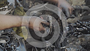 Mechanic tries to put chain on the pulley