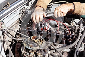 the mechanic uses a torque wrench to repair gas distribution mechanism at old engine. Disassembled carburetor motor. DIY