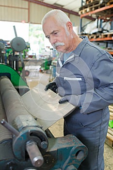 mechanic using industrial lathe machine