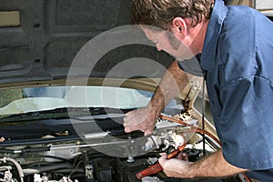 Mechanic Using Jumper Cables photo