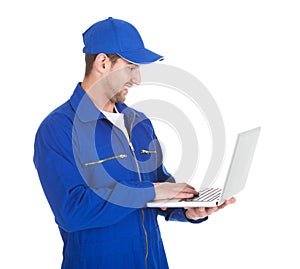 Mechanic Using Laptop Over White Background