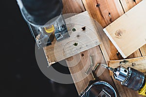 The mechanic is using wood cutting tools in construction