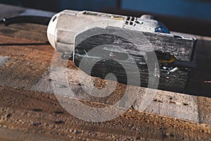 The mechanic is using wood cutting tools in construction