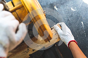 The mechanic is using wood cutting tools in construction