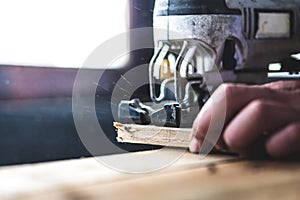 The mechanic is using wood cutting tools in construction