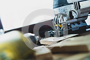 The mechanic is using wood cutting tools in construction