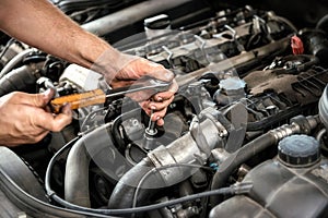 Mechanic using a wrench and socket