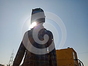 A mechanic wearing safety mask on sun light reflection with sky background isolated