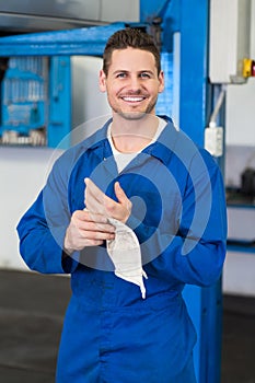 Mechanic wiping hands with rag