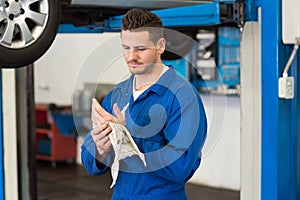 Mechanic wiping hands with rag