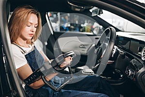 Mechanic woman with automotive diagnostic scanner