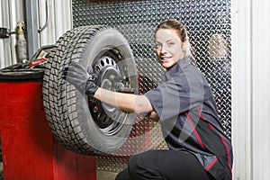 Mechanic woman working on car in his shop