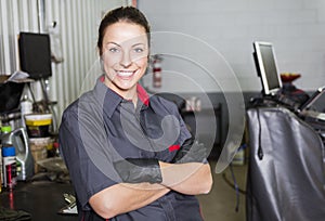 Mechanic woman working on car in his shop