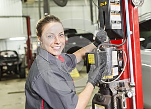 Mechanic woman working on car in his shop