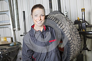 Mechanic woman working on car in his shop