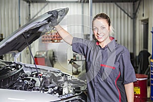 Mechanic woman working on car in his shop