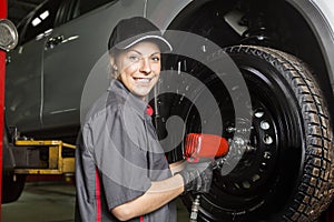 Mechanic woman working on car in his shop