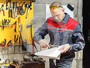 Mechanic worker studying his instructions