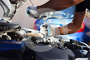 Mechanic working in auto repair garage. Car maintenance photo