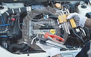 Mechanic working in auto repair. Hands of tools