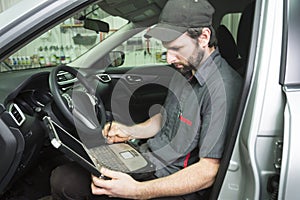 Mechanic working on car in his shop