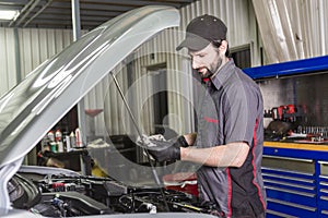 Mechanic working on car in his shop