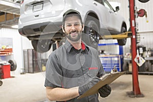 Mechanic working on car in his shop