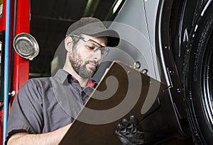 Mechanic working on car in his shop