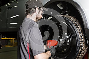 Mechanic working on car in his shop