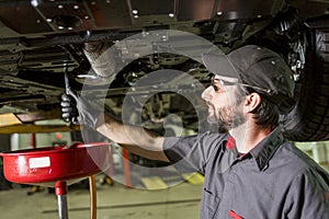 Mechanic working on car in his shop