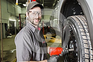 Mechanic working on car in his shop