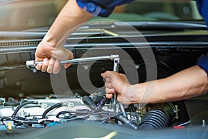 Mechanic working on engine in auto repair shop