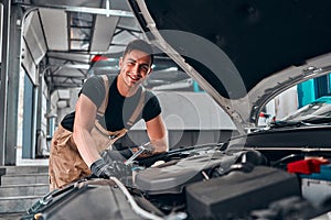 Mechanic working on engine in auto repair shop