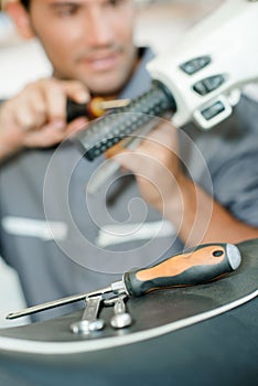 Mechanic working on handlebars scooter