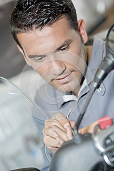 Mechanic working on handlebars scooter