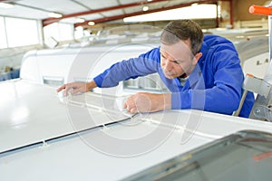 Mechanic working on roof camper van