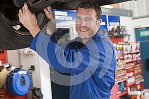 Mechanic working under car