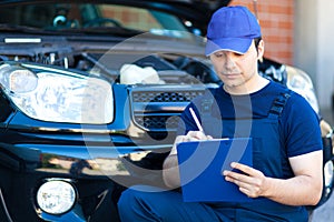 Mechanic writing on clipboard