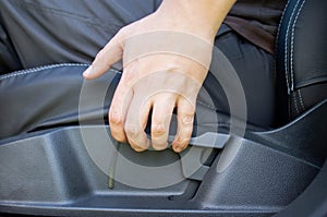 Mechanical adjustment of the height of the driver`s seat in the car, close-up